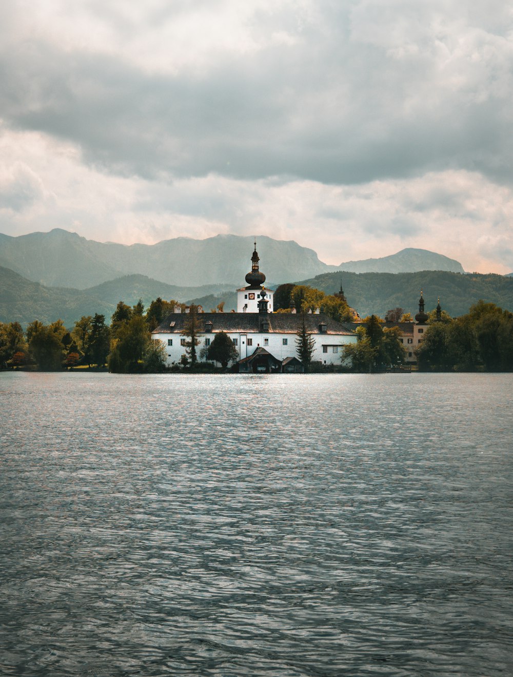 a large white building sitting on top of a lake