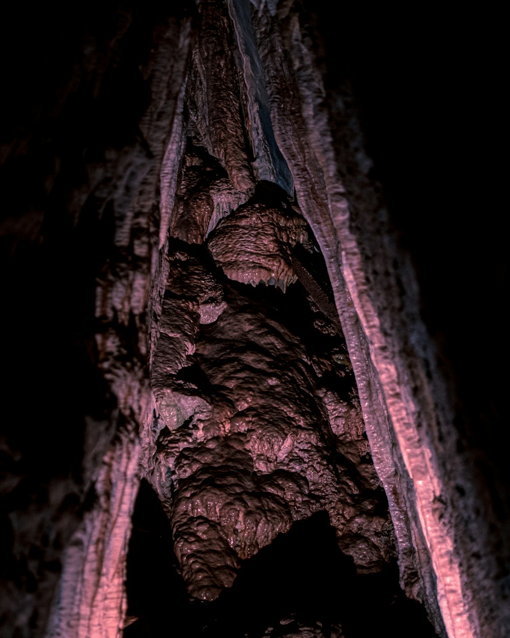 a group of people standing inside of a cave