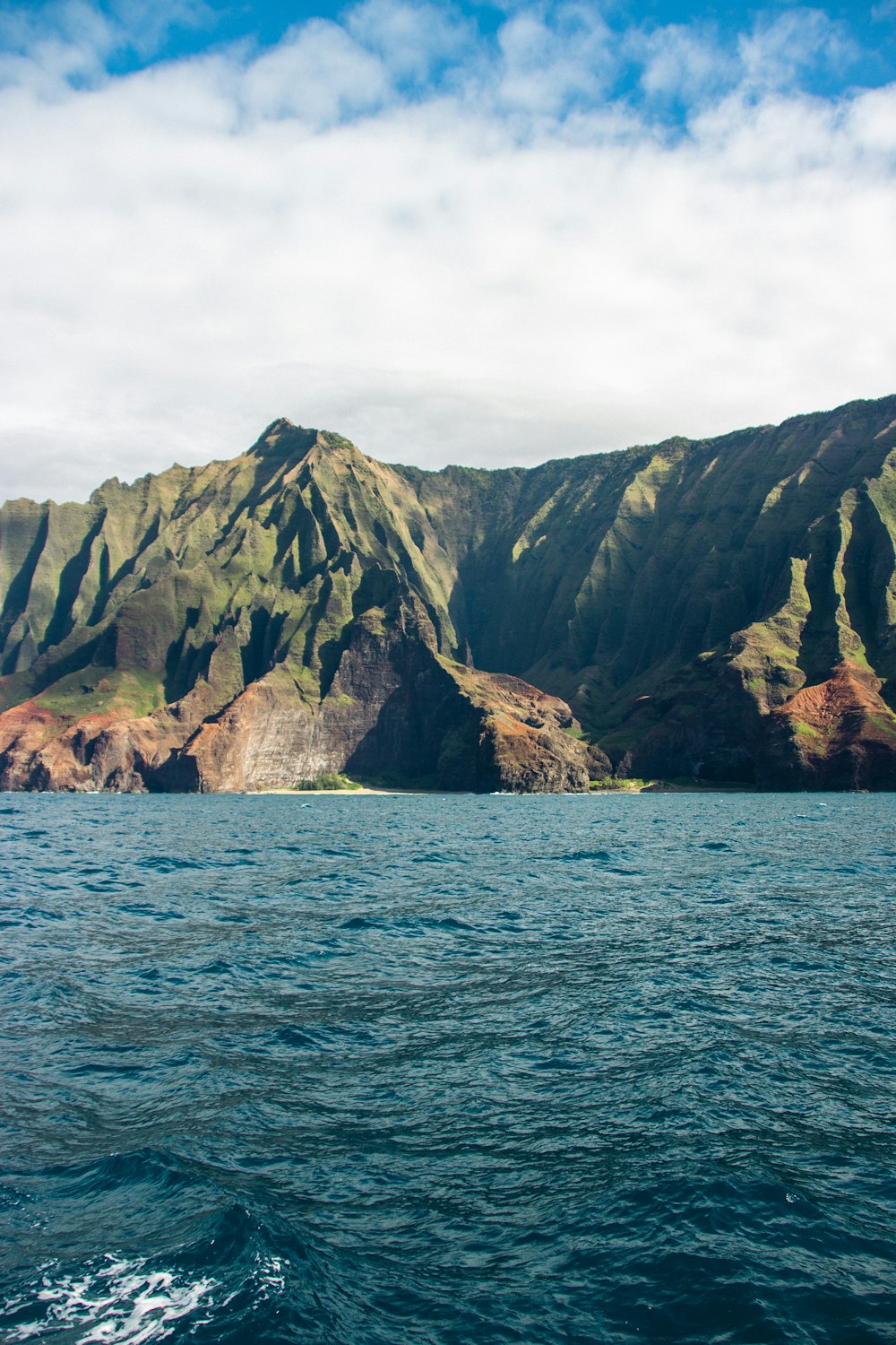 a large body of water with mountains in the background