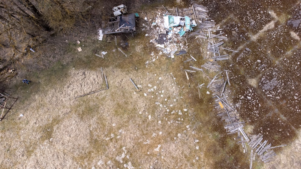 an aerial view of an abandoned house in a field