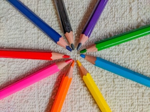 A set of colorful no-point pencils arranged neatly in a holder.