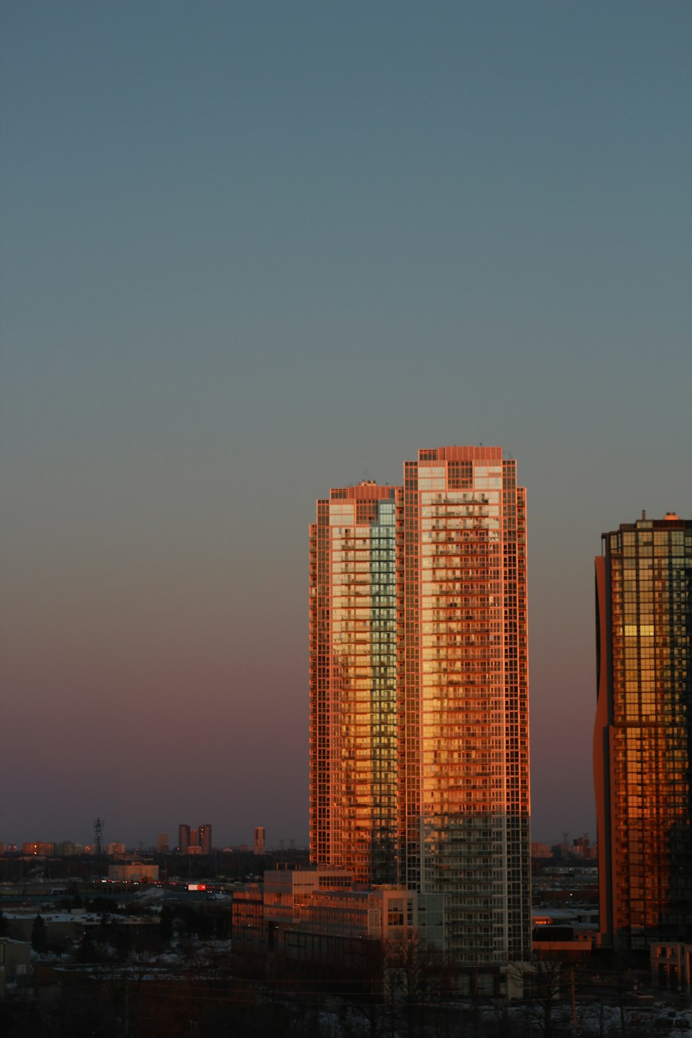 a couple of tall buildings sitting next to each other