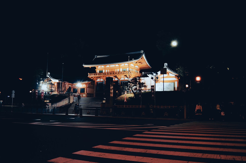 a building lit up at night with street lights