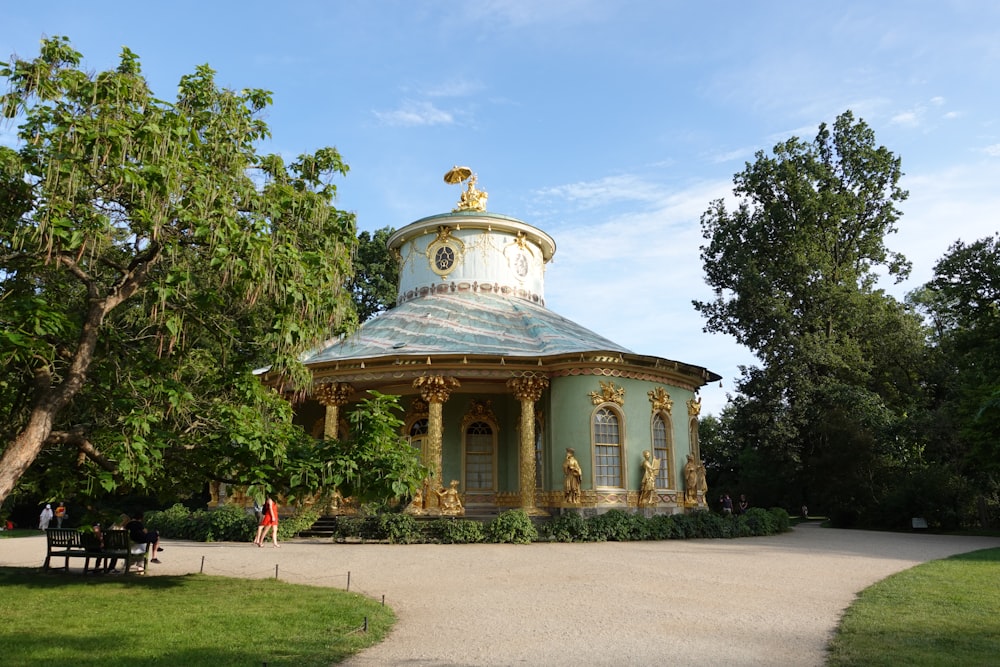 a gazebo in the middle of a park surrounded by trees