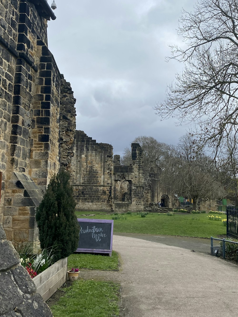 a sign in front of a stone building