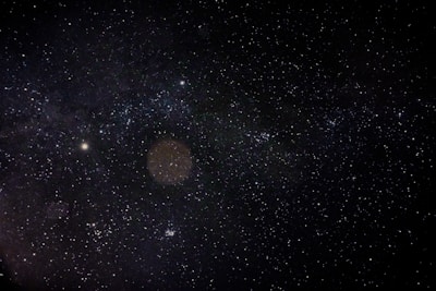 A vast expanse of the night sky filled with countless stars, creating a mesmerizing cosmic view. The stars vary in brightness and are scattered throughout the dark, seemingly infinite space.