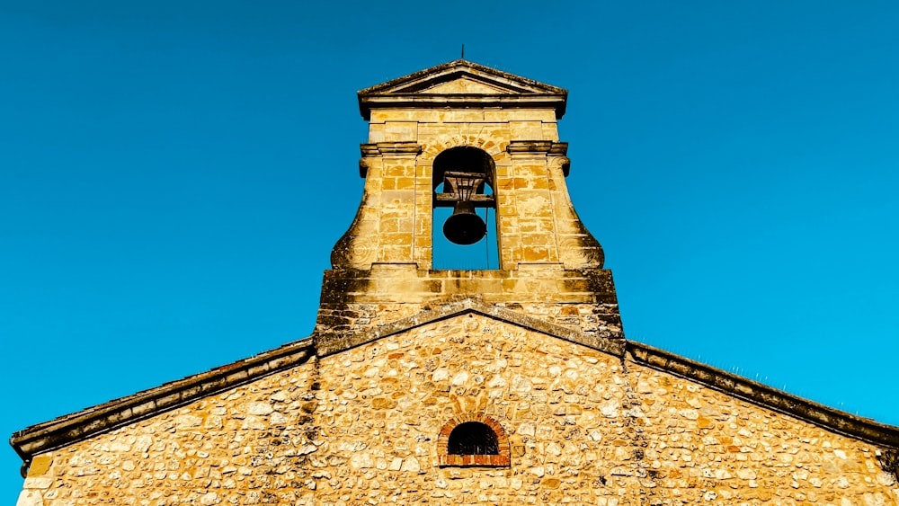 a church bell tower with a blue sky in the background
