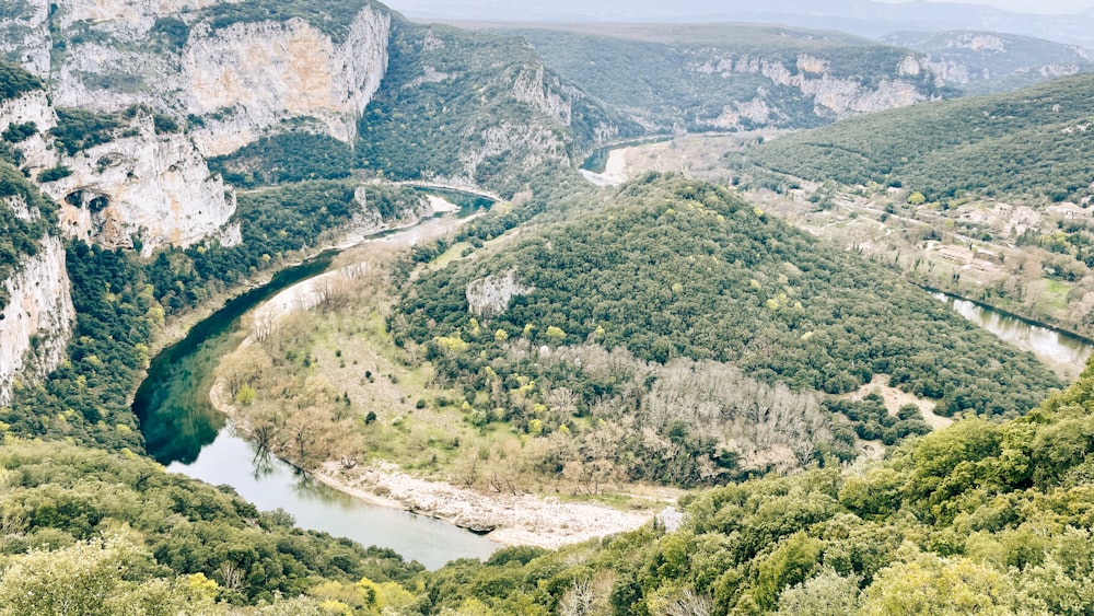 a river flowing through a lush green valley