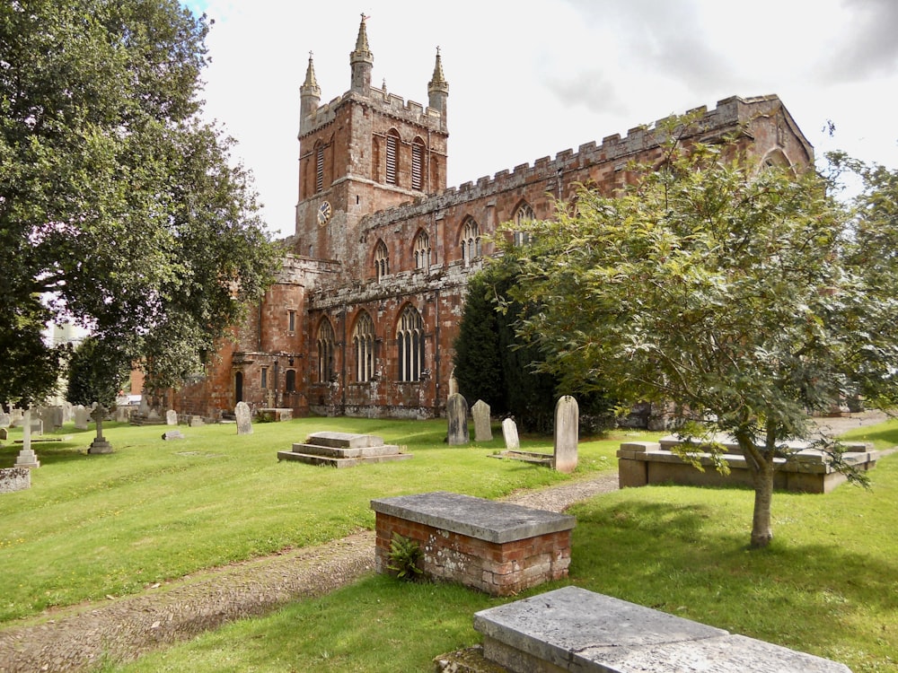 an old church with a cemetery in the foreground