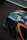 A close-up of a sports car's rear section with aerodynamic features. The car is adorned with racing decals and has a sleek, modern design. The tire's branding is visible, and a QR code is present on the car's body.