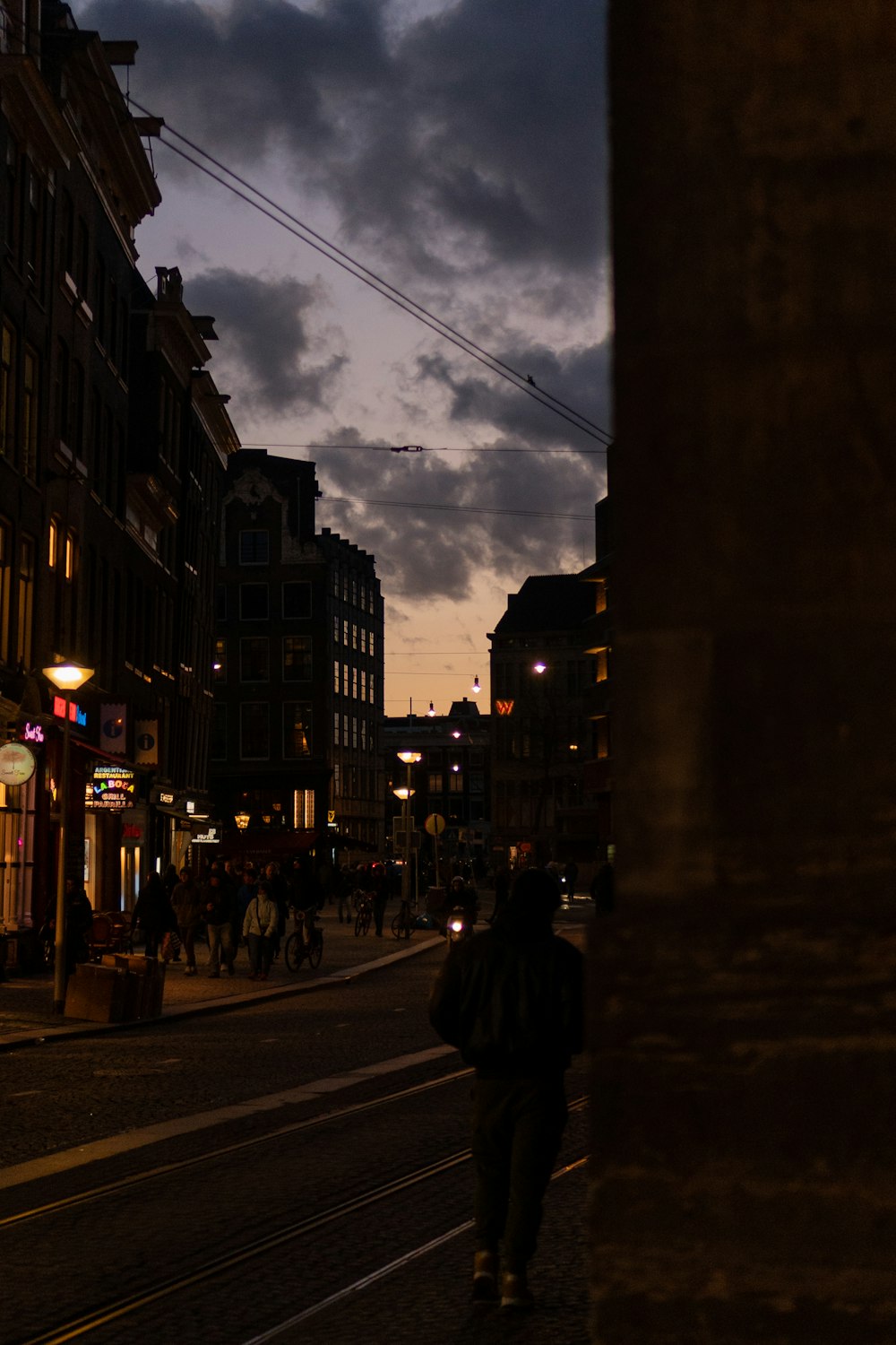 a person walking down a street at night