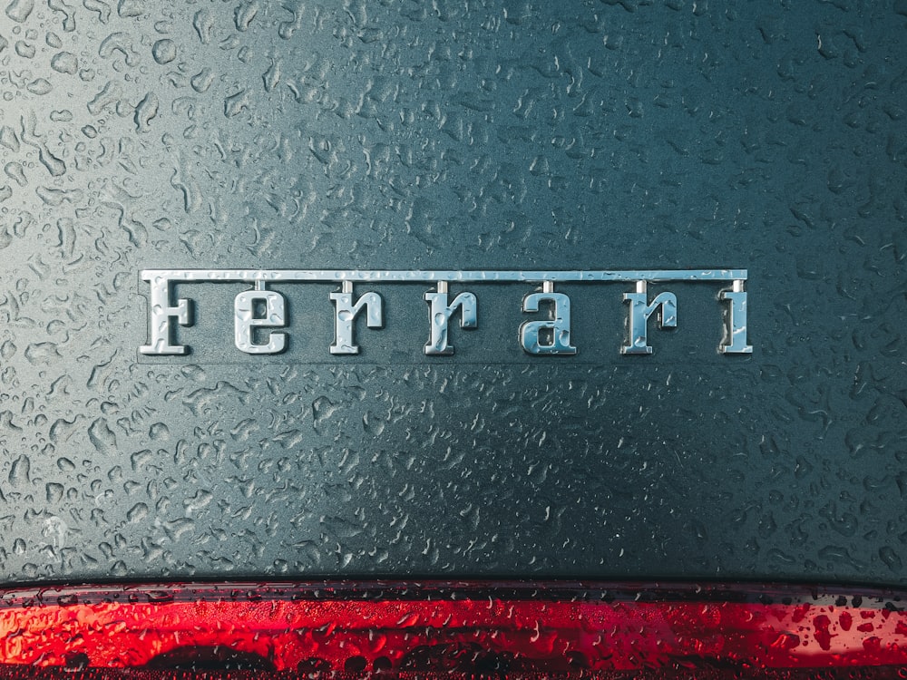 a close up of the word ferrari on the side of a car