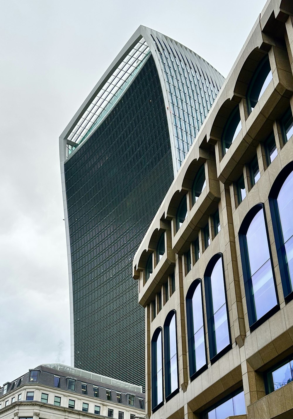 a large building with a very tall building in the background