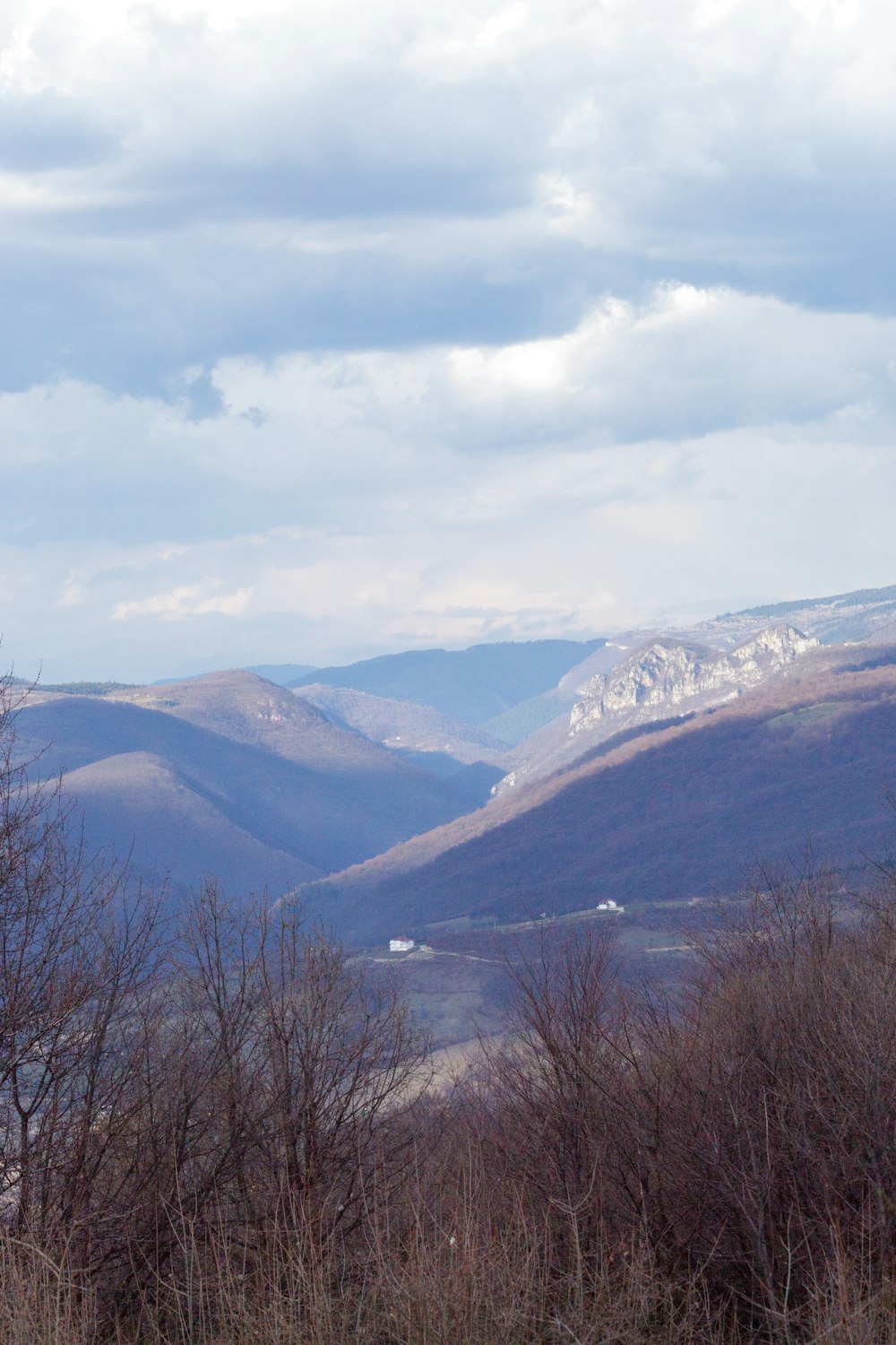 a view of a valley with mountains in the background