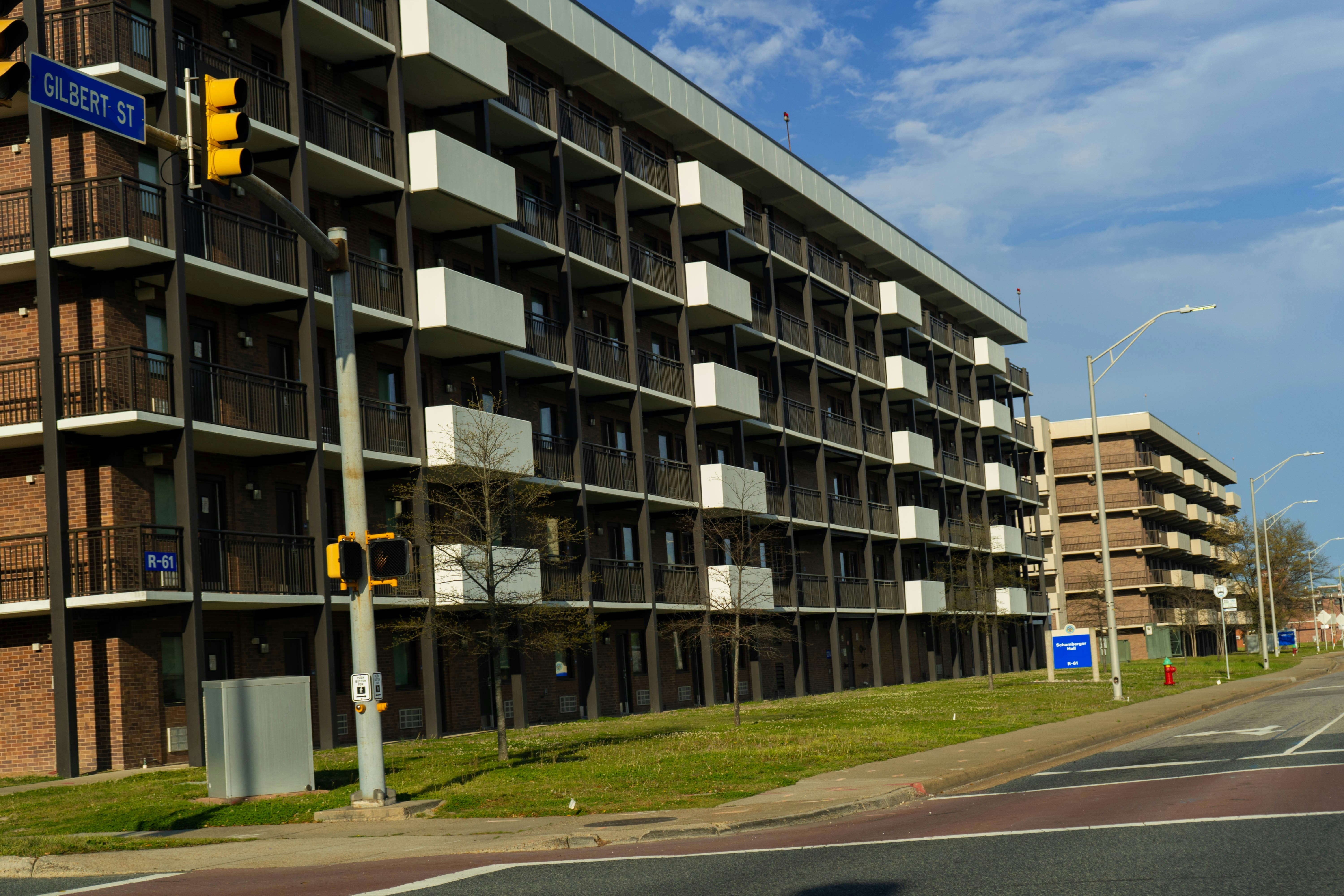 a tall building sitting next to a street filled with traffic lights