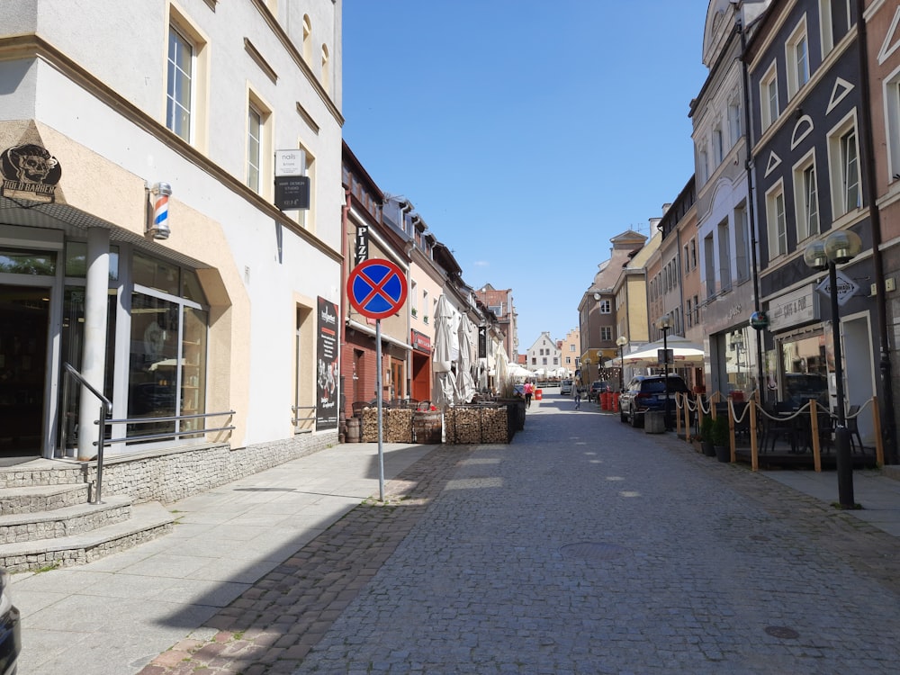 a cobblestone street lined with buildings and shops