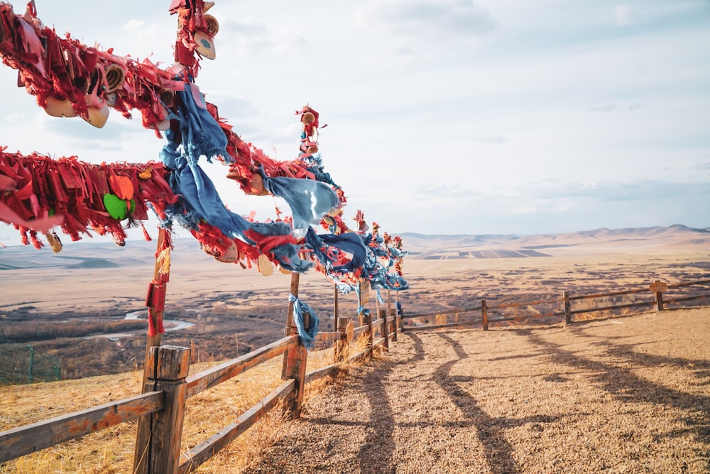 a wooden fence covered in red and blue streamers