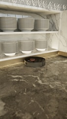 a room with a bunch of plates on the floor
