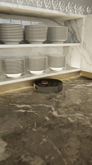 A sleek handheld vacuum cleaner on a modern kitchen countertop.