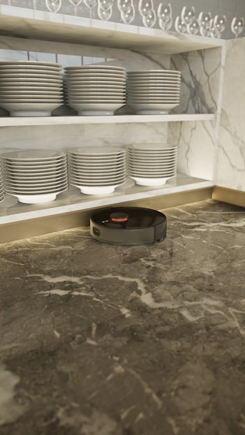 A sleek handheld vacuum cleaner on a modern kitchen countertop.