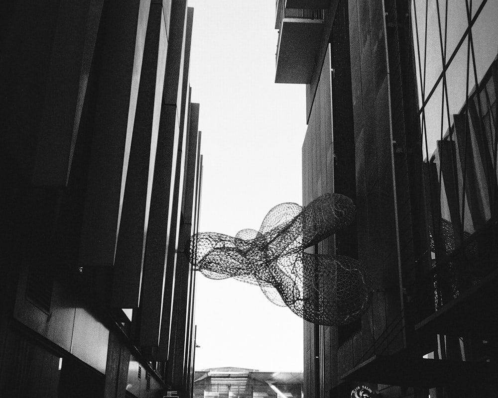 a black and white photo of a person walking down a street