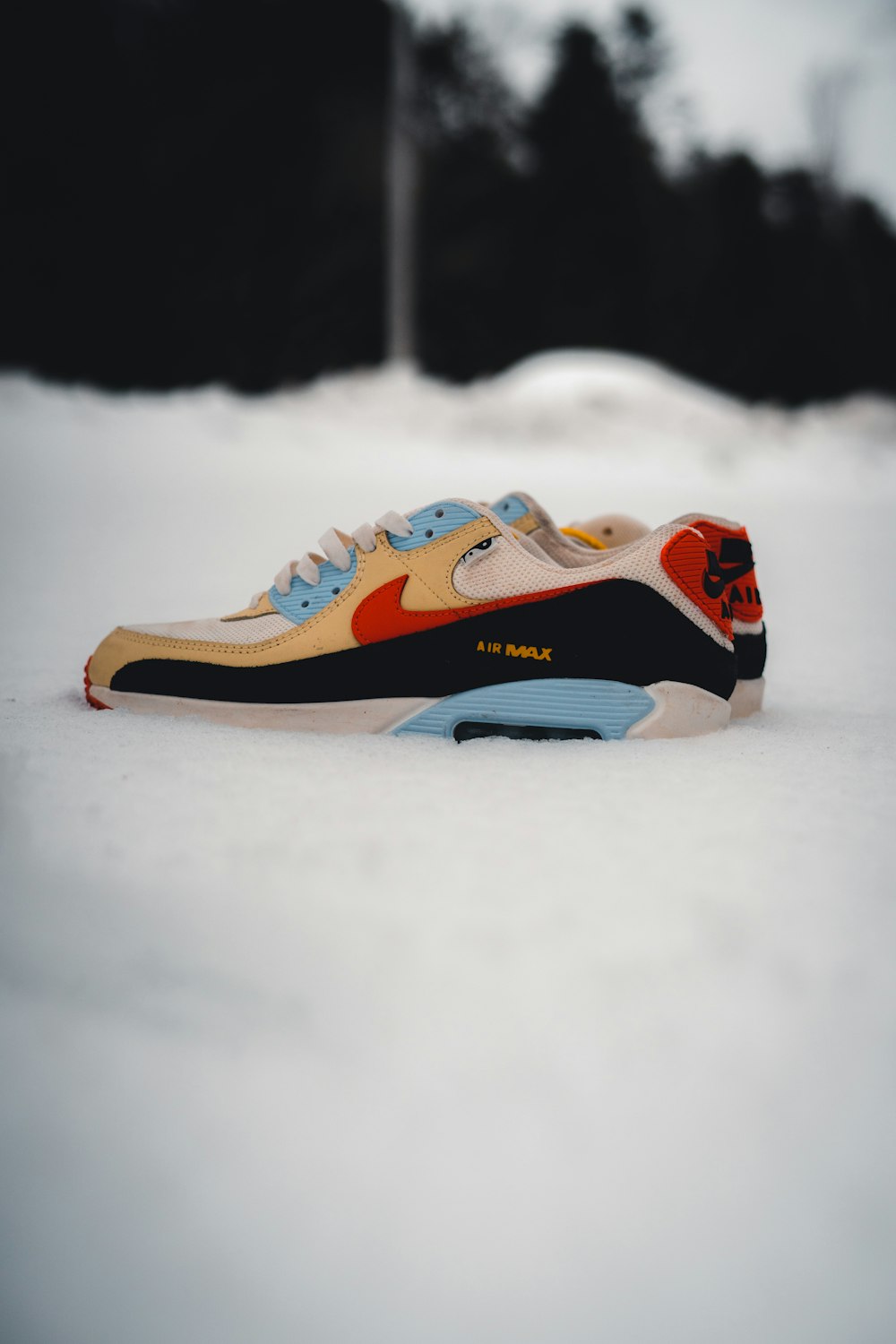 a pair of sneakers sitting in the snow