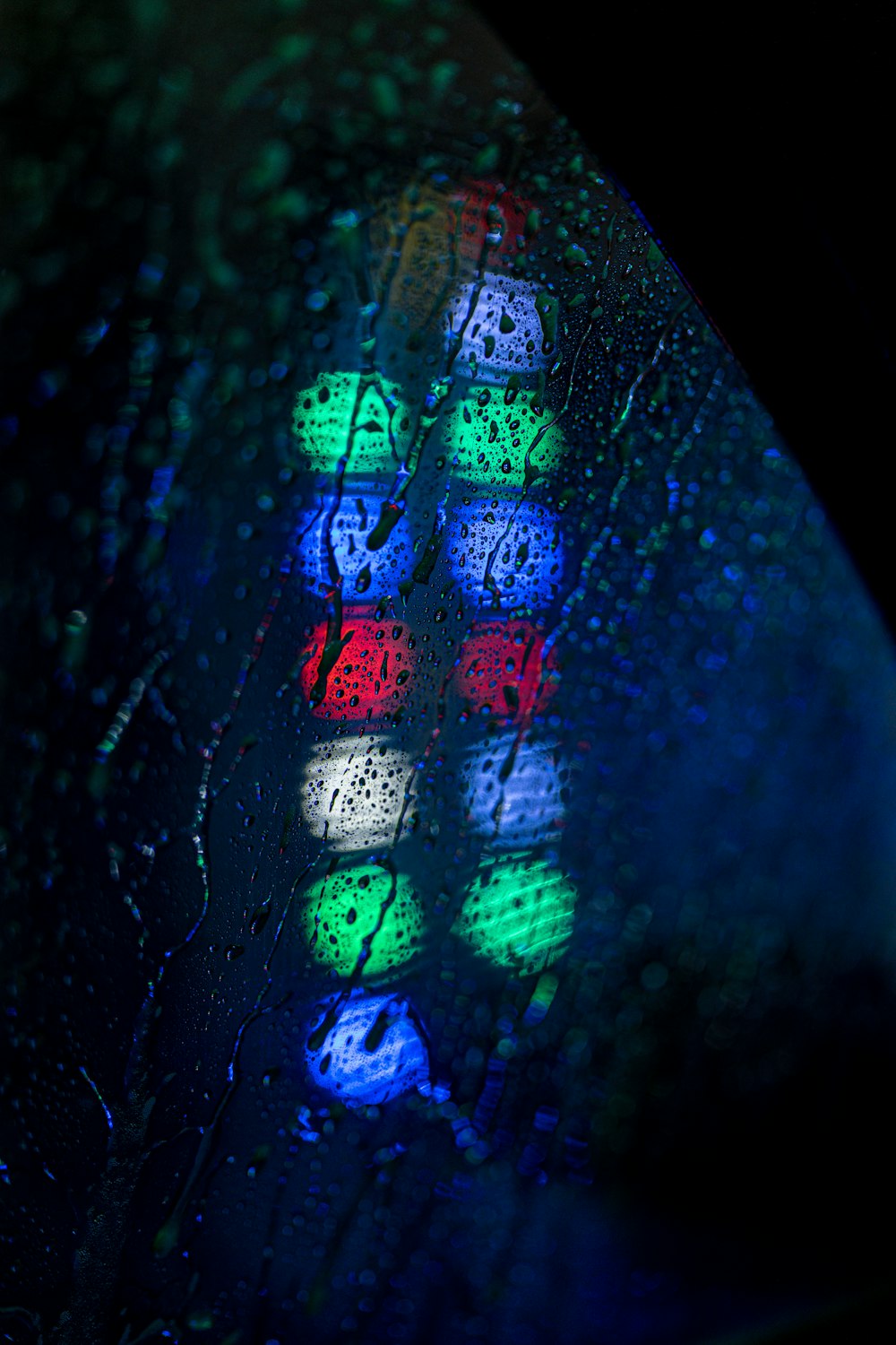 a close up of a traffic light on a rainy day