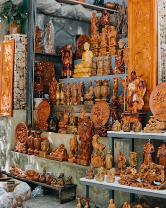 a room filled with lots of wooden carvings and figurines