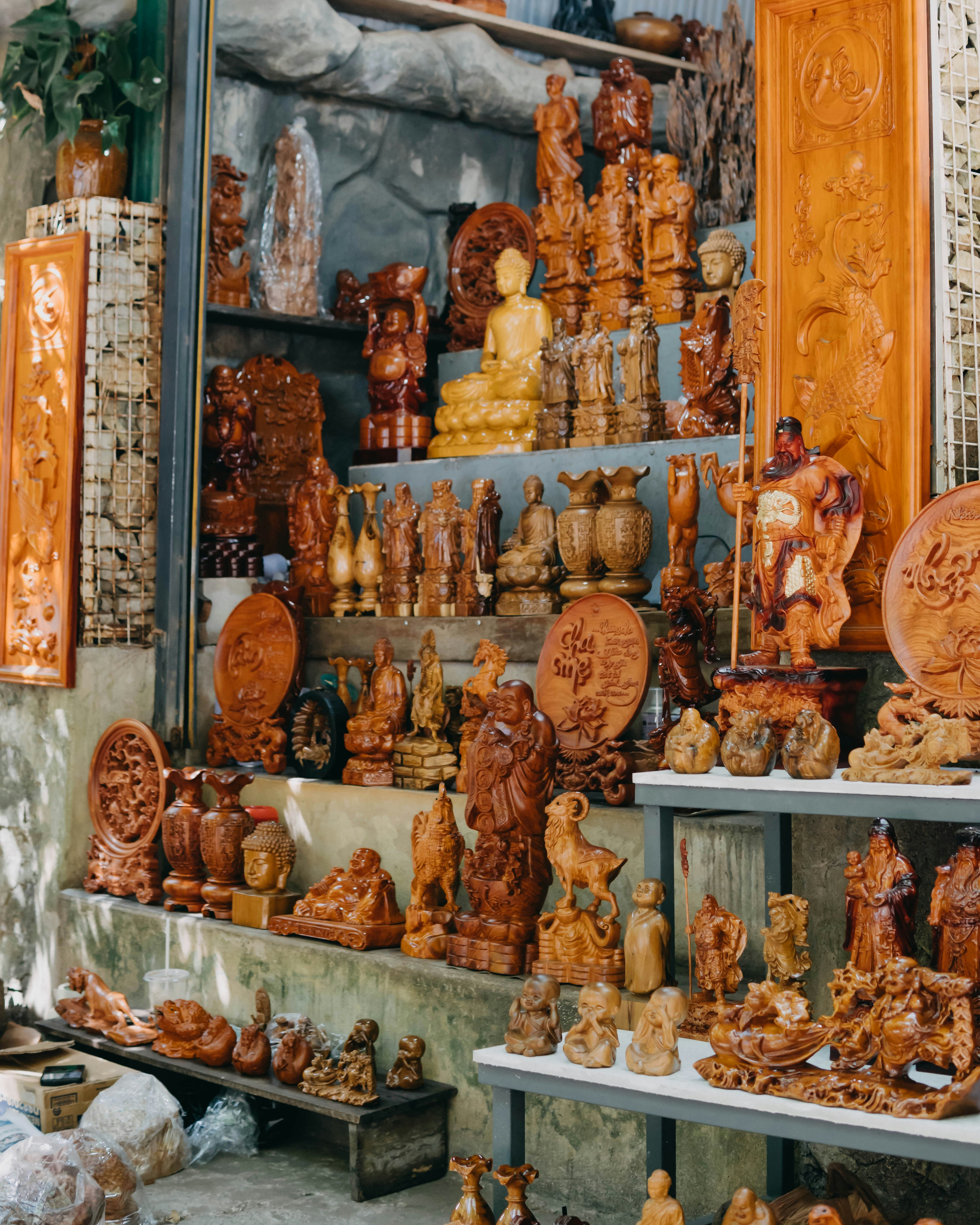 a room filled with lots of wooden carvings and figurines