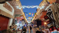 A vibrant market street bustling with colorful stalls and smiling locals under warm golden light.