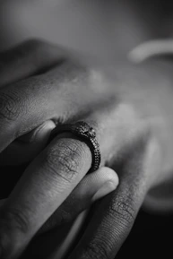 Detailed shot of a men's ring with a matte black finish, highlighting its texture.