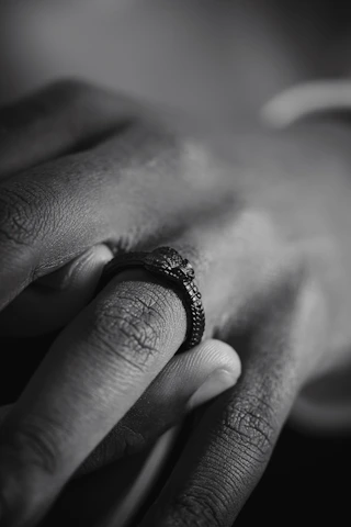 Detailed shot of a men's ring with a matte black finish, highlighting its texture.