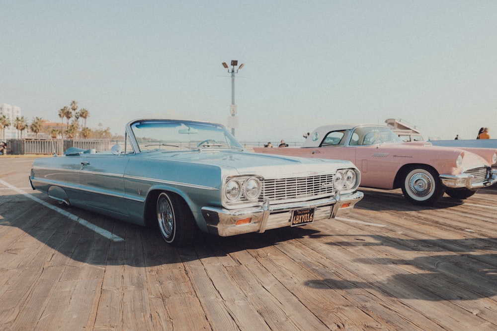 a couple of old cars parked next to each other