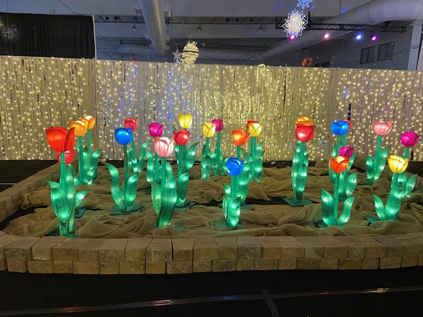 Artistic display of narcissus bulbs arranged with intricate root patterns and subtle traditional Tet motifs in warm lighting.