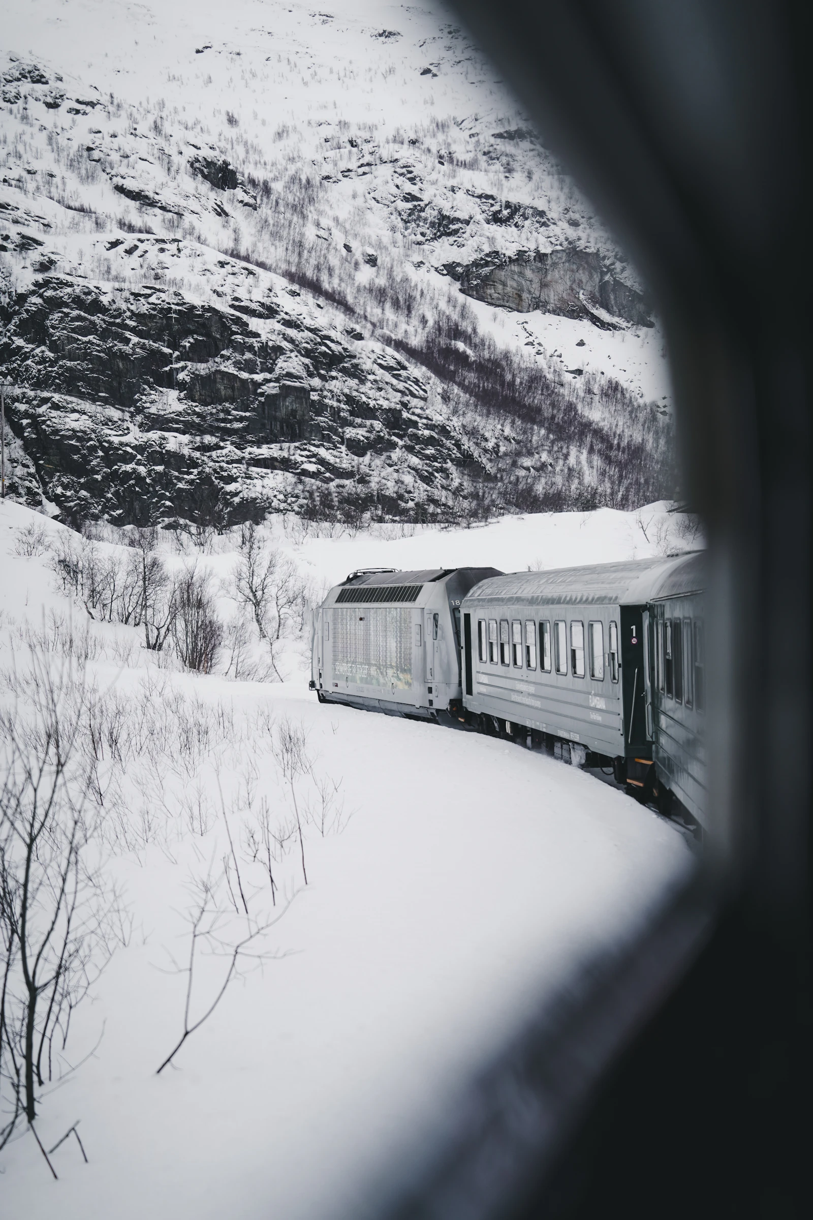 Train crossing a snow-covered landscape in Norway