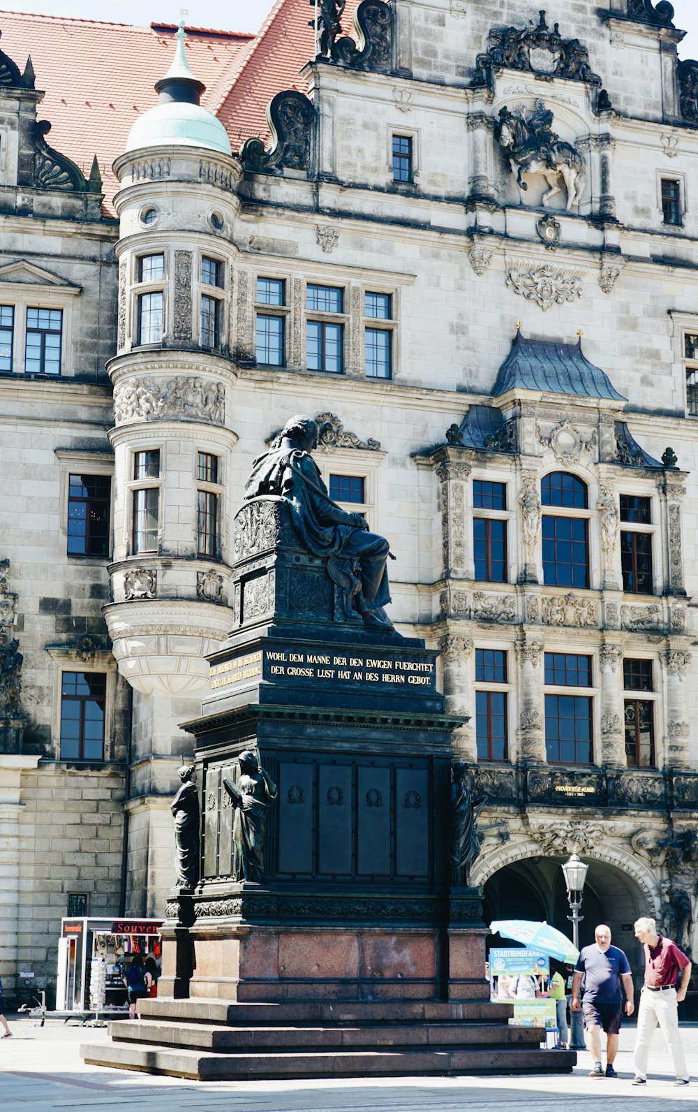 a large building with a statue in front of it