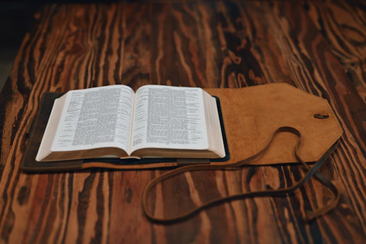 an open book sitting on top of a wooden table