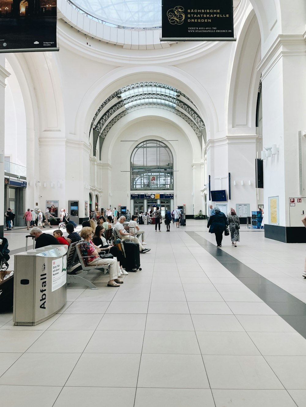 a group of people sitting on benches in a building