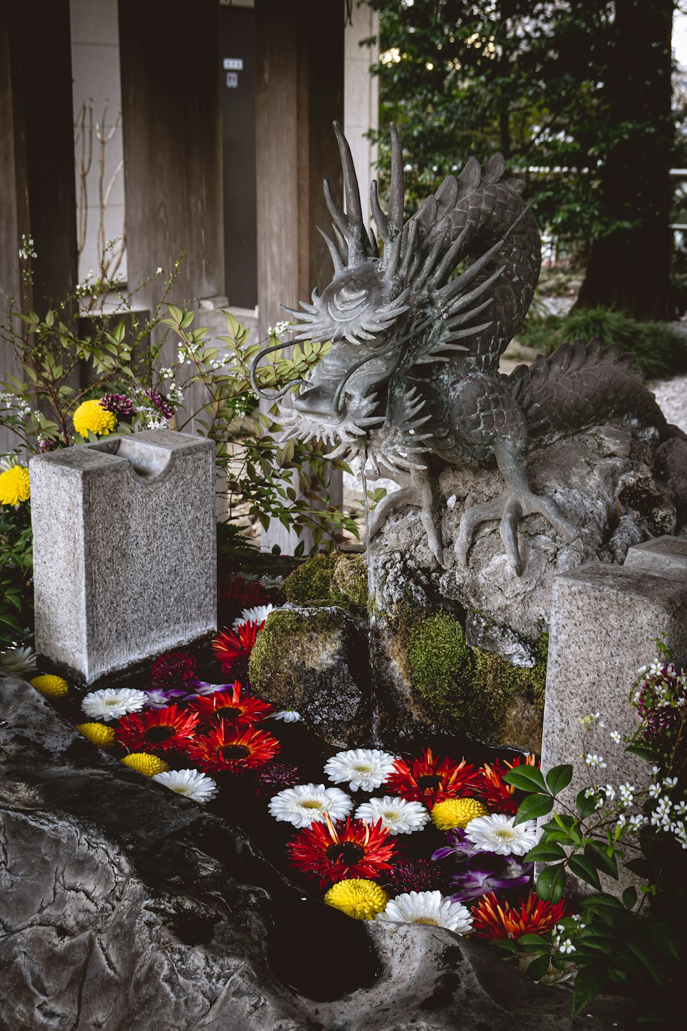 a statue of a bird sitting on top of a rock