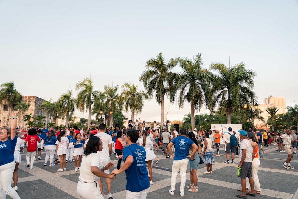 a large group of people walking across a street