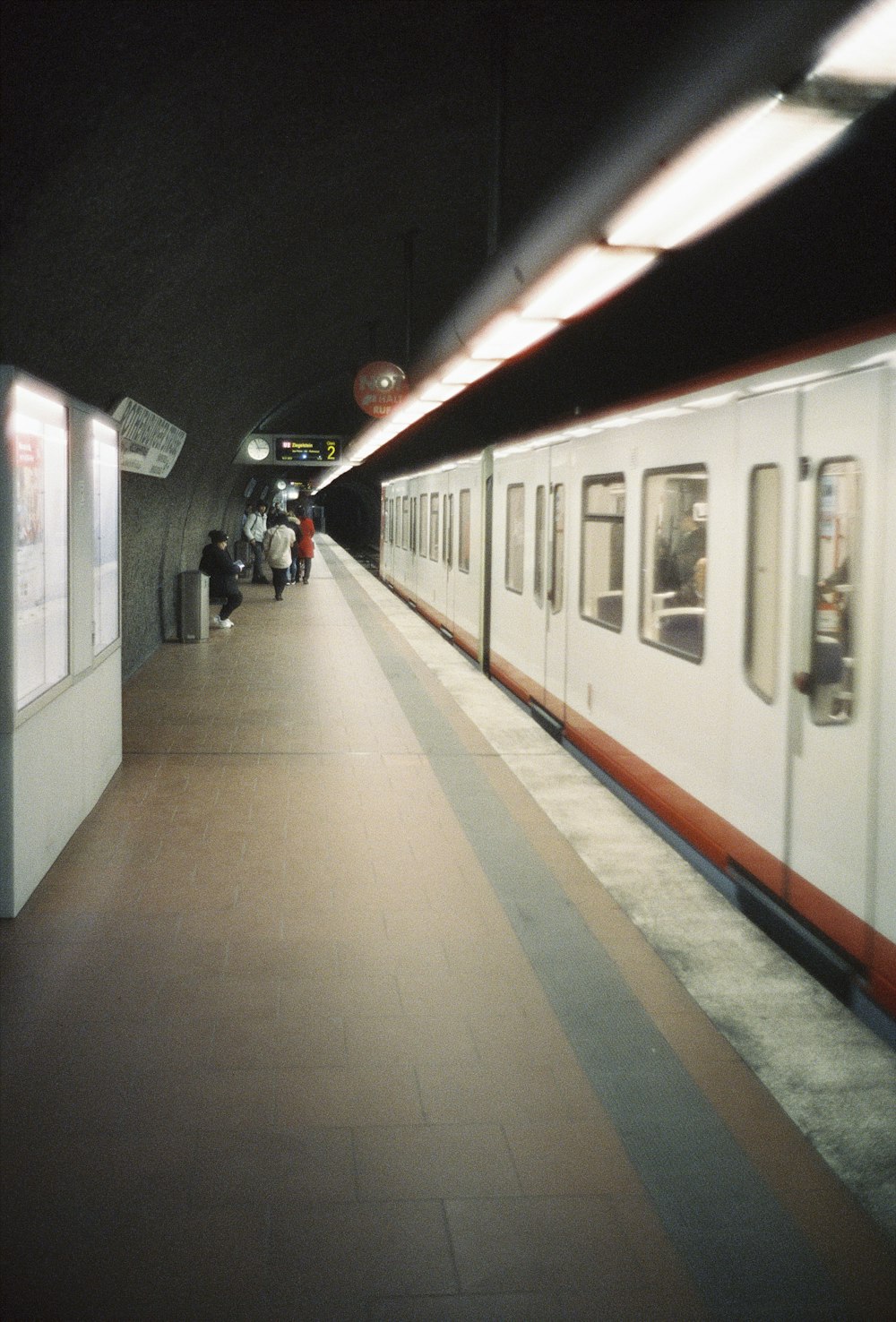 Ein Zug, der neben einem Bahnsteig in einen Bahnhof einfährt