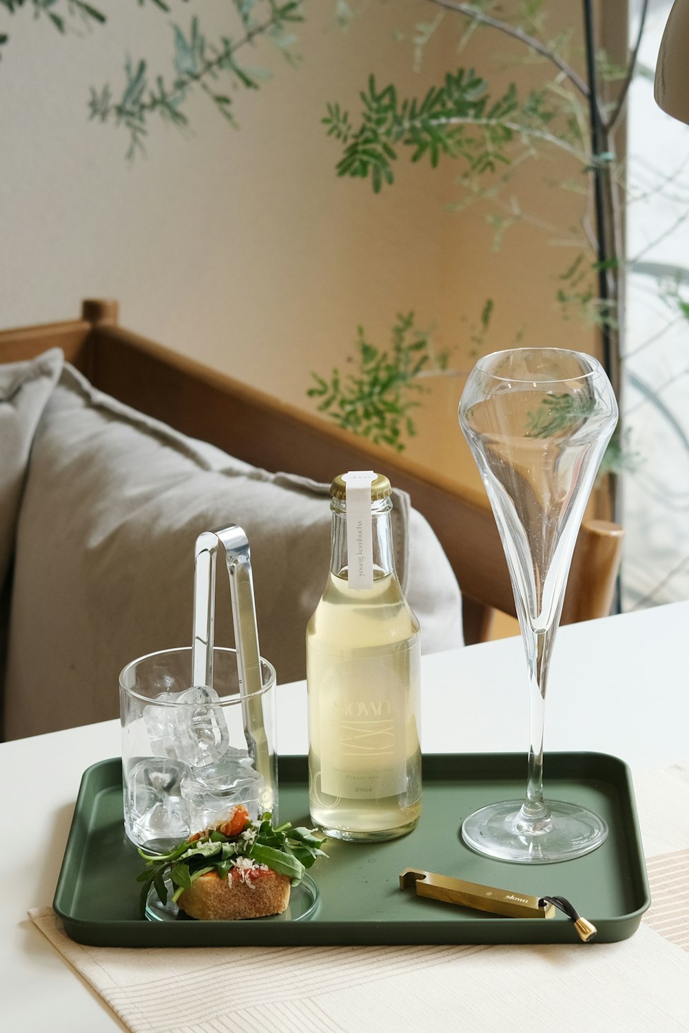 a tray with a bottle of wine and two glasses on it