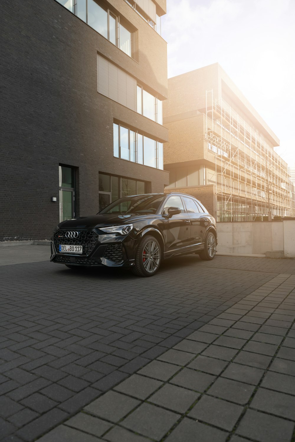 a black car parked in front of a building