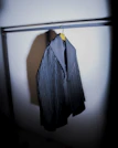 A cozy wool coat displayed on a hanger with soft natural lighting.
