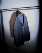 A cozy wool coat displayed on a hanger with soft natural lighting.