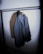 Elegant winter coat hanging on a minimalist rack in a bright boutique setting