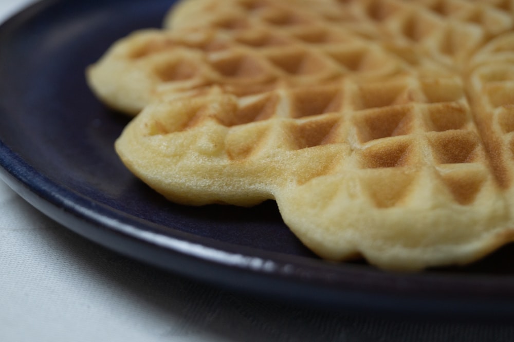 two waffles on a blue plate on a table