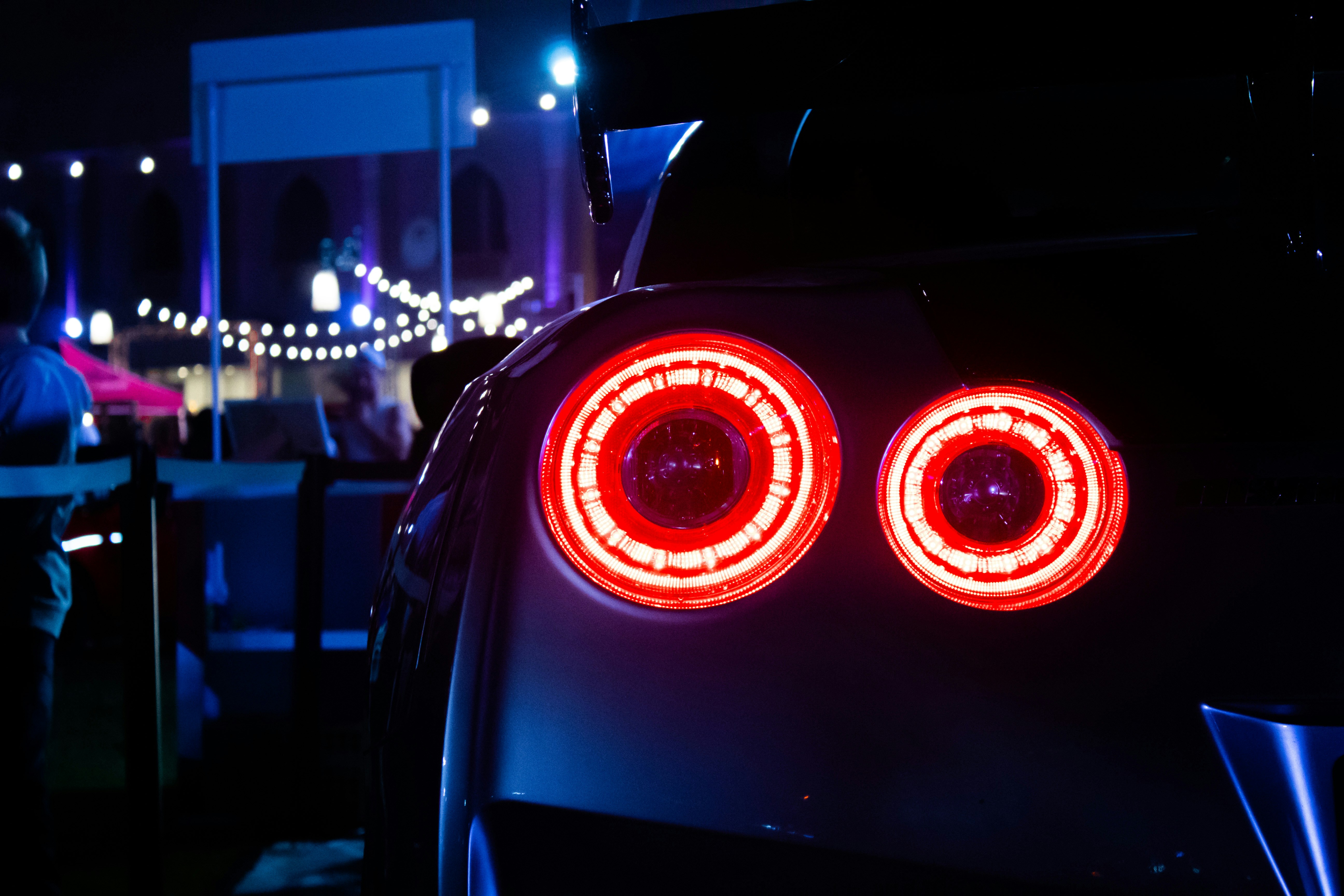An electrical car plugged into a home wall charger in a modern garage