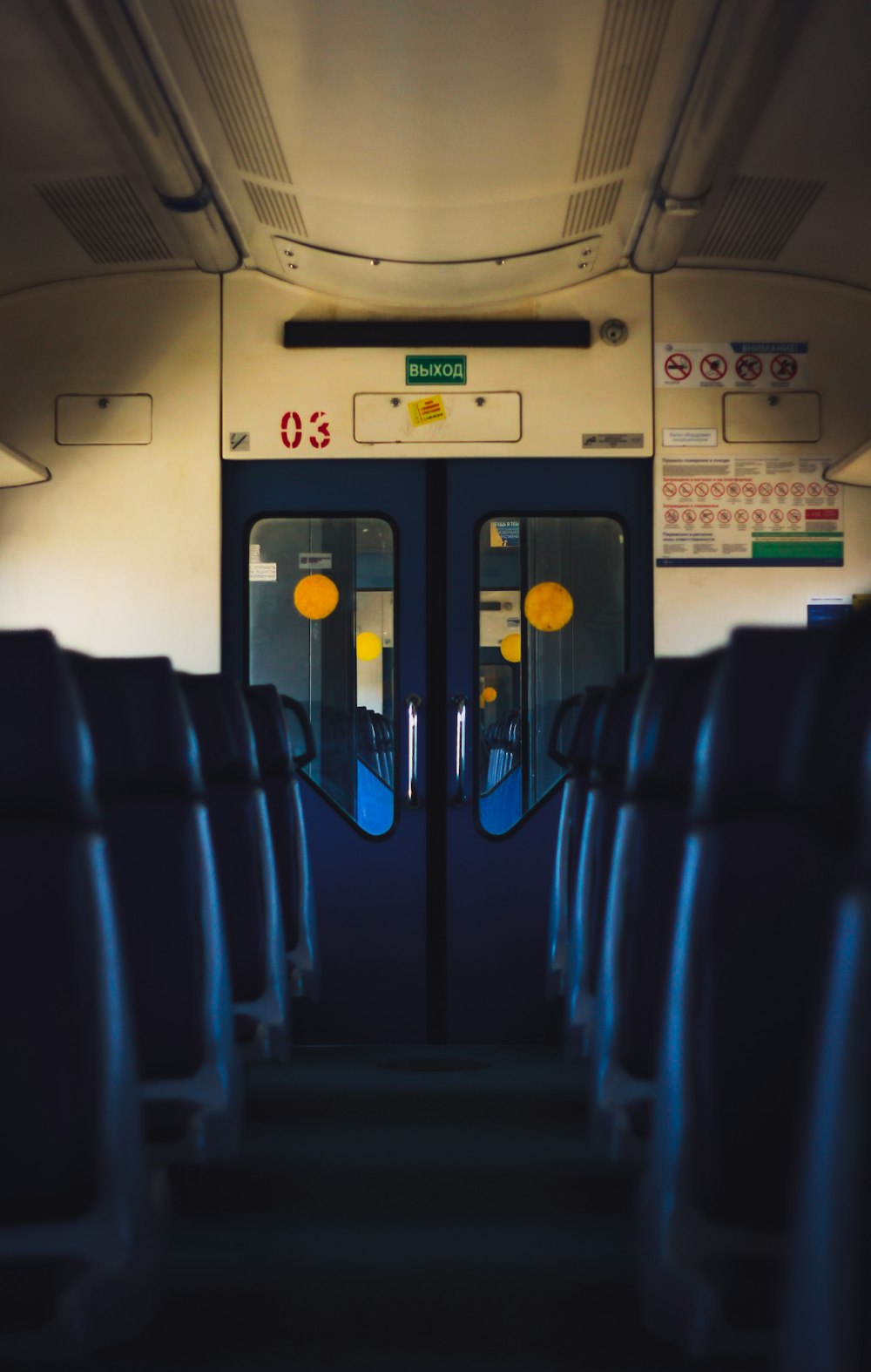 the inside of a train with blue seats