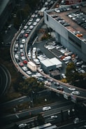 An aerial view of a busy interstate with multiple trucks traveling in both directions.